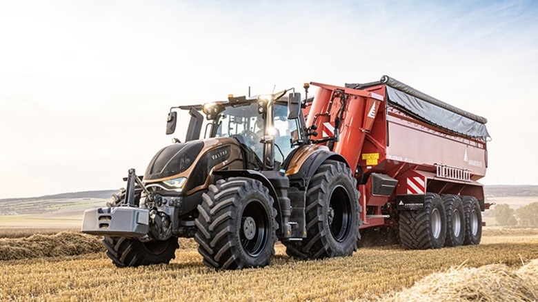 Person driving a Valtra tractor in a field