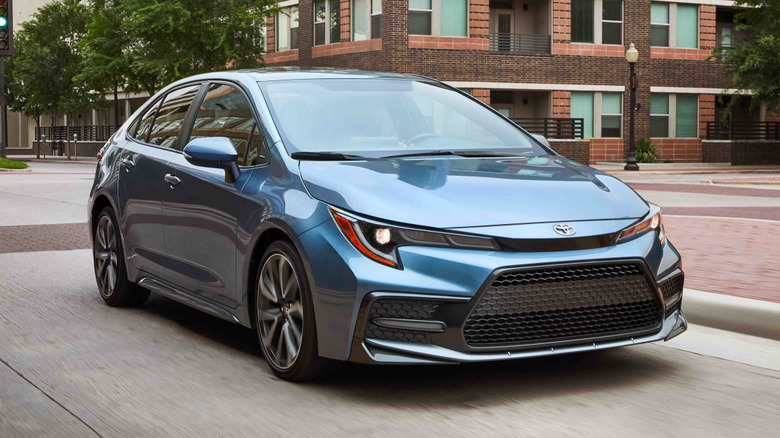 Blue 2022 Toyota Corolla driving in the city