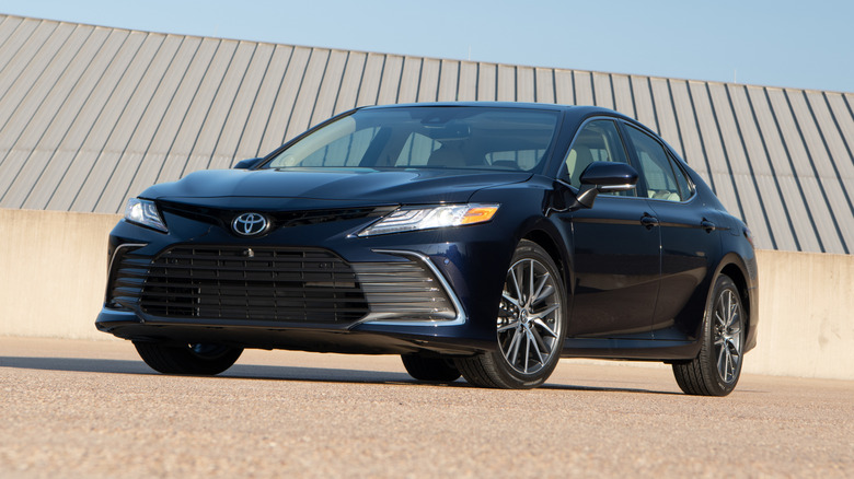 Black 2021 Toyota Camry parked in front of a structure