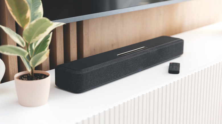 A soundbar below a TV in a living area.