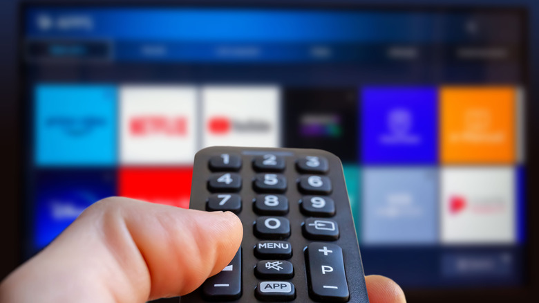 Person using smart TV remote