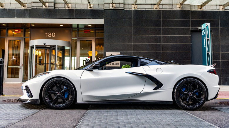 White Corvette Z06 parked outside building