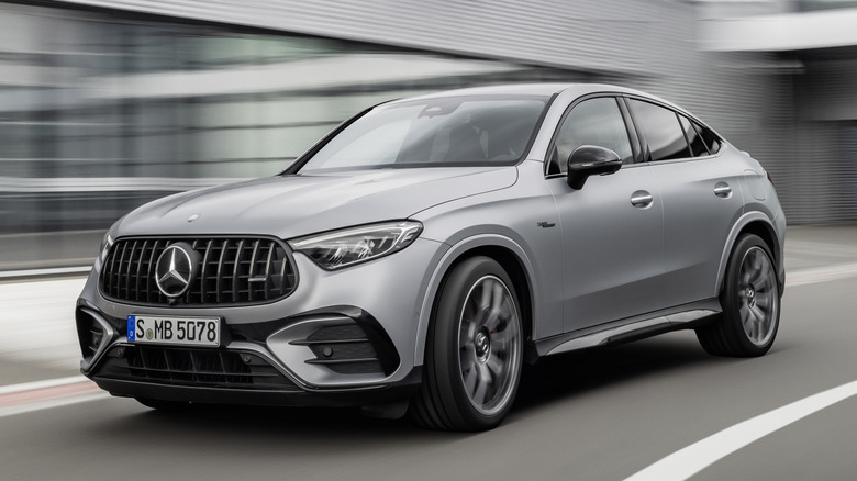 Front 3/4 view of Mercedes-AMG GLC 63 S Coupe with blurred background