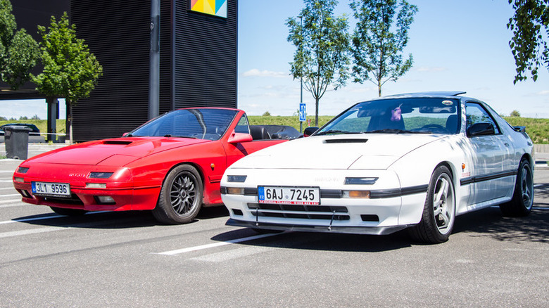 Two Mazda RX-7 cars, red and white