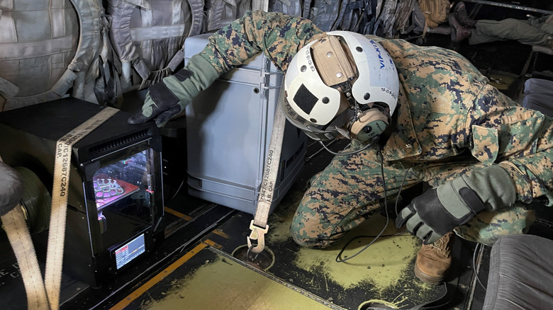 Lt. Col. Michael Radigan checks on the 3D printing of a medical cast aboard an MV-22 Osprey from Marine Medium Tiltrotor Squadron (VMM) 164 during a training flight near Twentynine Palms, California.