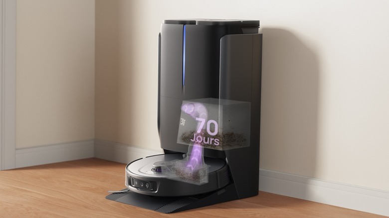 A black 3- P10 Ultra robot vacuum in station on wood floor