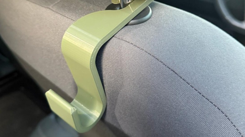An organization hook on the back of a car seat.
