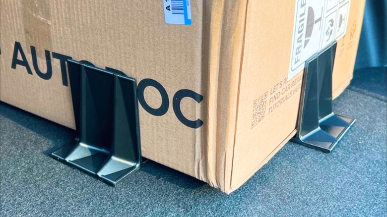 A box held by 3D-printed cargo holders.