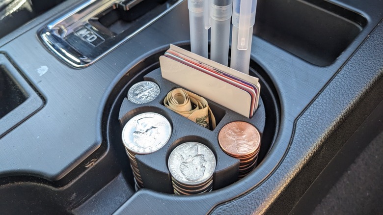 A 3D-printed organizer in a car's cup holder.