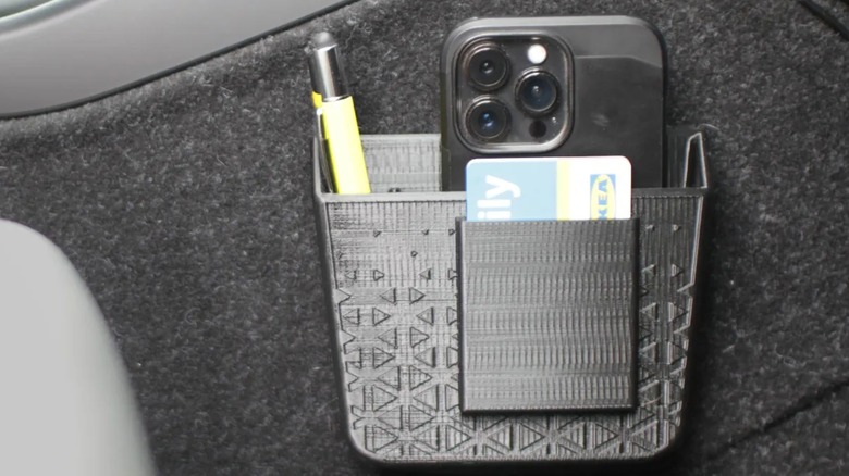 A 3d-printed car organizer full of items.