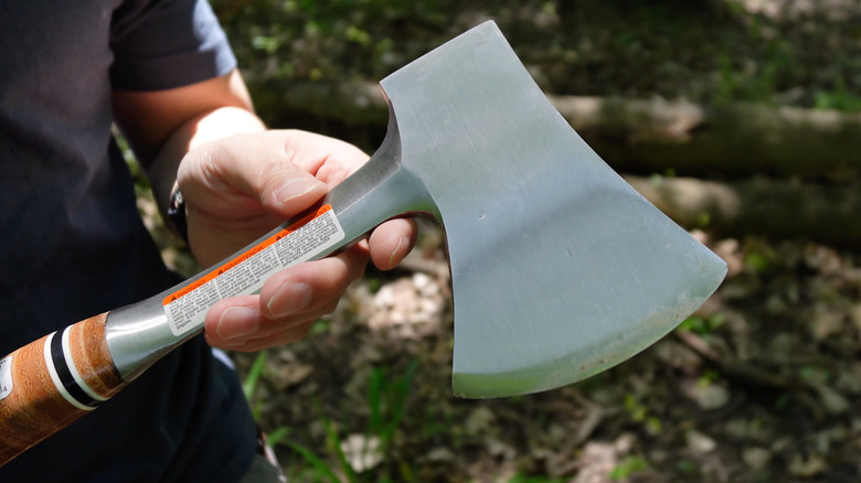 A person demonstrating the Estwing axe in the sunlight