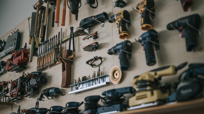 A wooden wall with various tools