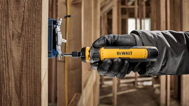 person using a DeWalt Cordless Screwdriver with FlexDrive Control on a light switch