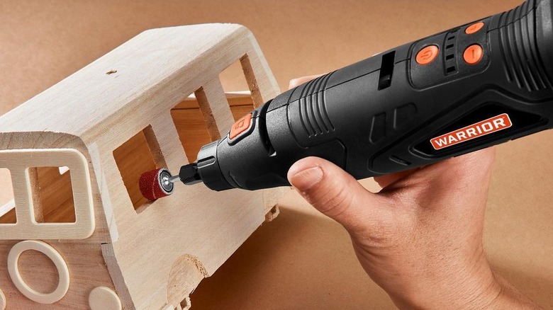 Rotary tool sanding wooden model