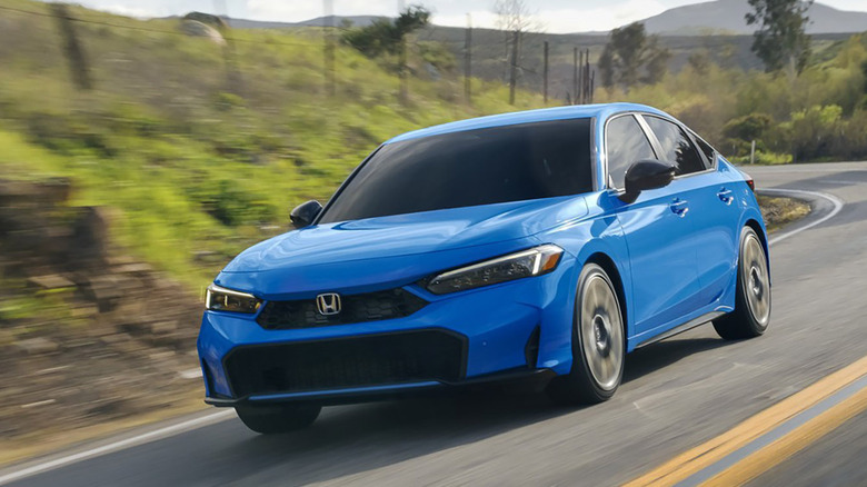 Blue 2025 Honda Civic Hatchback driving