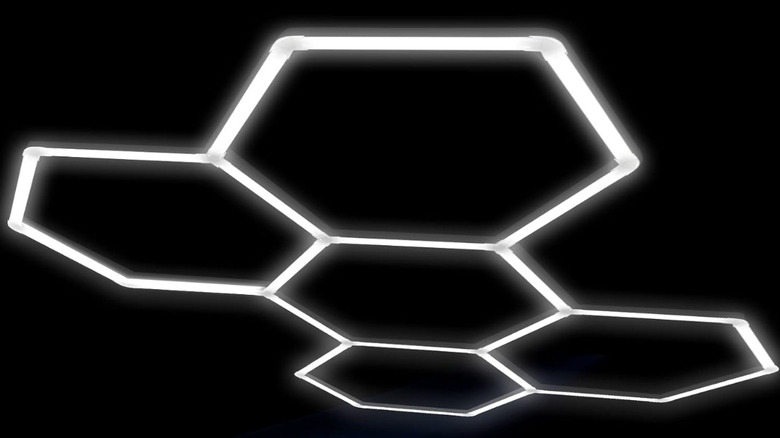 The LZHOME Hexagon LED Garage Light seen on a dark surface with five lit hexagons