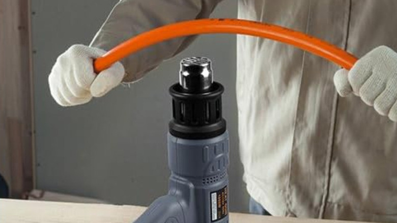 A heat gun used to bend a tube