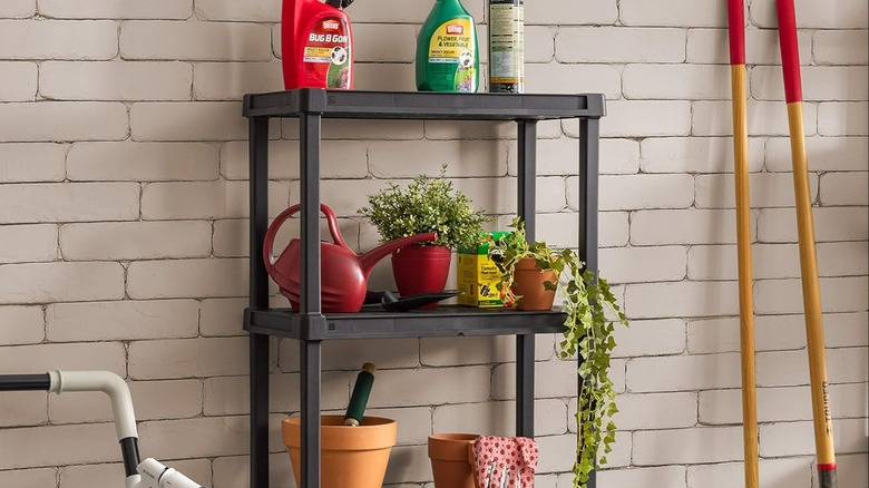 A plastic shelf holding gardening items.