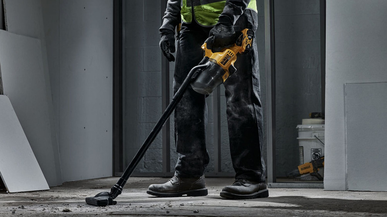 Person using DeWalt 20V cordless vacuum