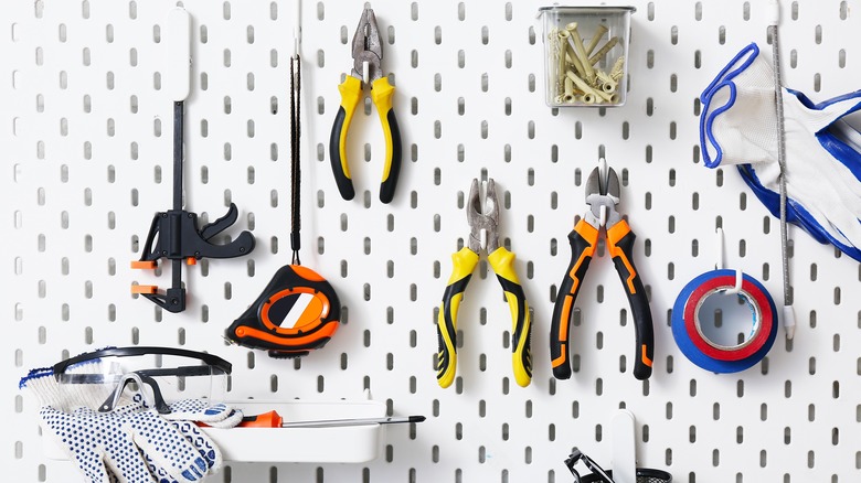 Various tools on a peg board.