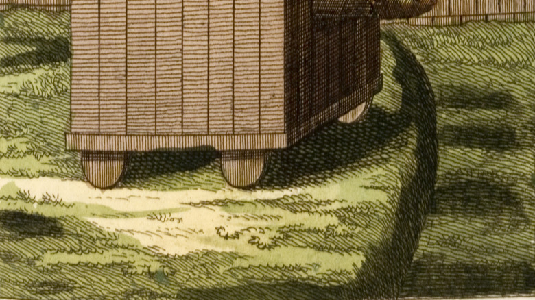 Image of a siege tower approacing fortifications.
