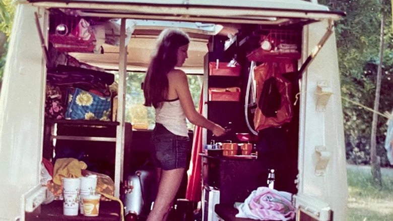 woman preparing food in camper in 1970s