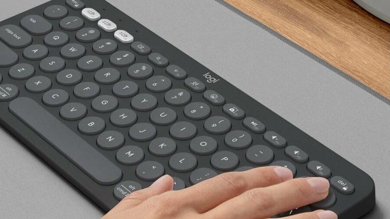A person using Logitech K380 keyboard