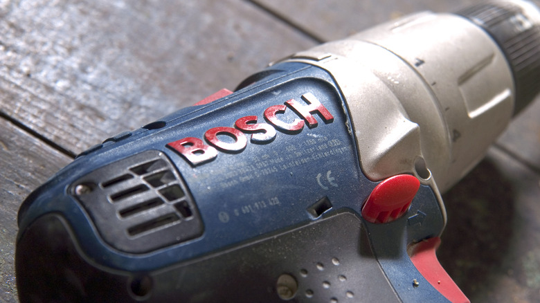 A Bosch power tool sitting on a wood surface