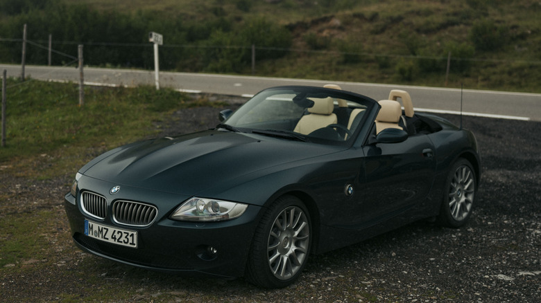 A black BMW Z4 roadster parked off a rural road