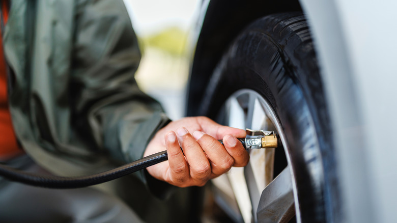 Close-up of an person putting air into their car's tire