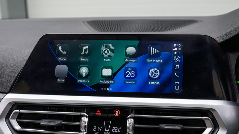 An interior of a BMW showcasing Apple's new Liquid Glass CarPlay interface.