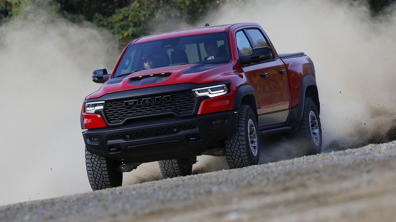 2025 Ram 1500 RHO driving off-road with a dust cloud behind