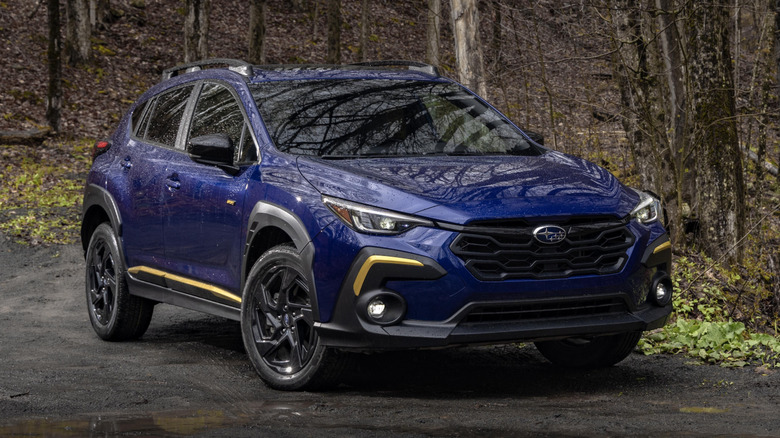 blue Subaru Crosstrek sport in a forest