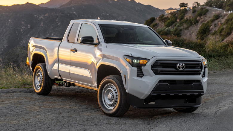 white Toyota Tacoma parked on the side of a desert road