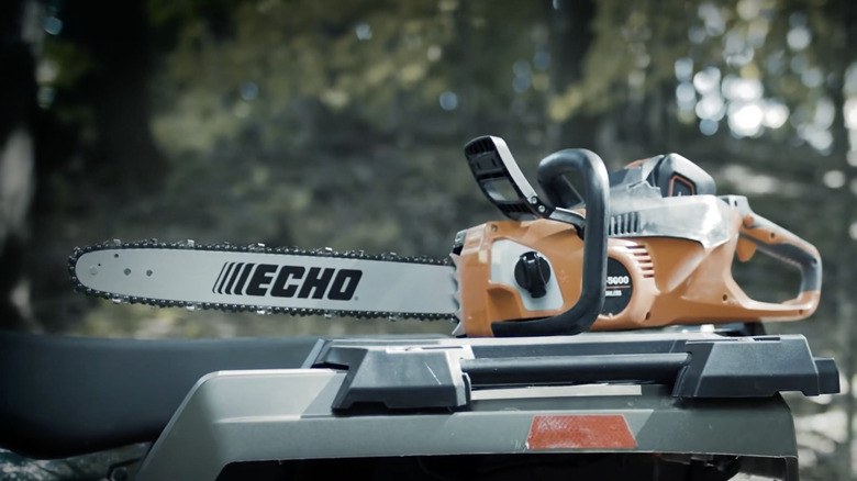 An Echo DCS-5000 56V Battery Chainsaw on a work bench in the woods