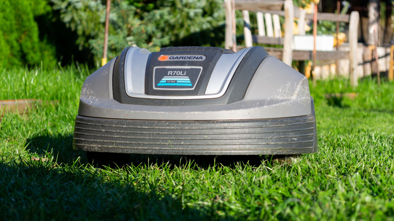 Gardena robot mower on grass during a sunny day.