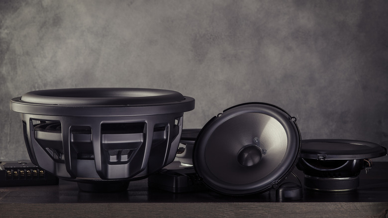 Car speakers and subwoofer on grey table