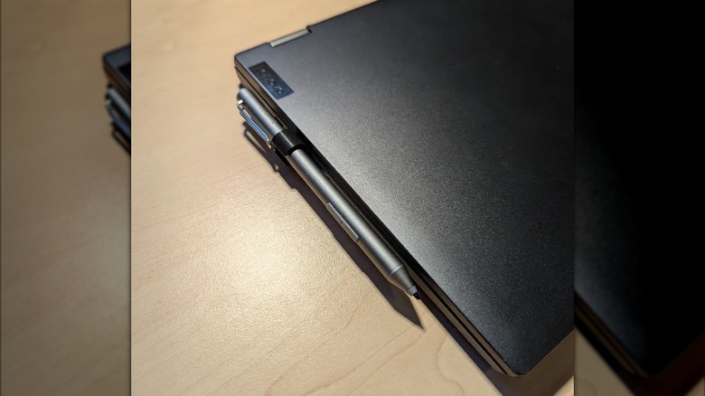 A stylus attached to a laptop with a 3D printed stylus holder.