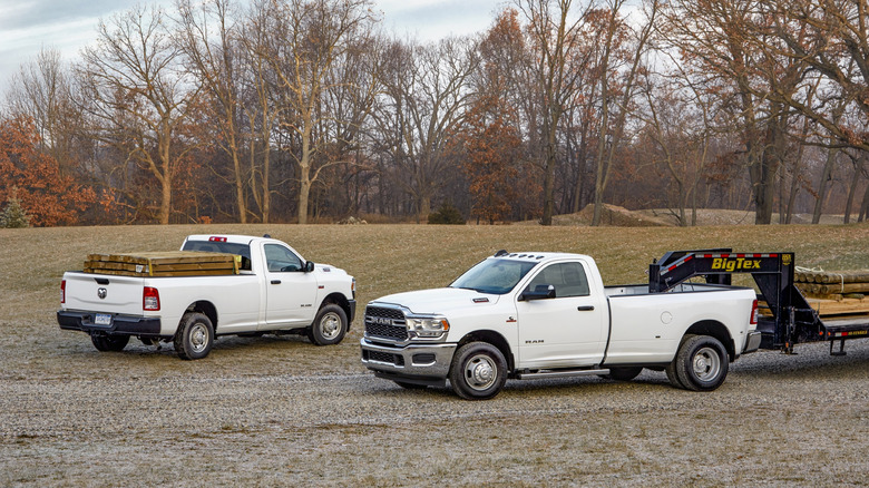 2021 Ram 2500 and 3500 HD Diesel trucks hauling cargo on a farm