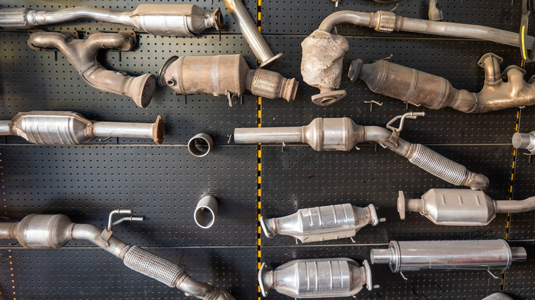Collection of catalytic converters hanging on wall