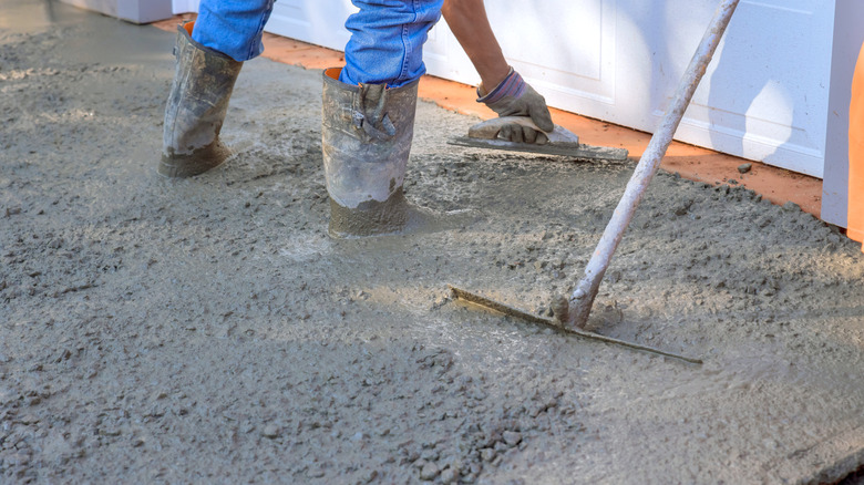 legs of worker installing a concrete driveway