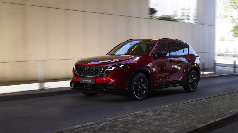 2026 Mazda CX-5 in red driving along an urban road