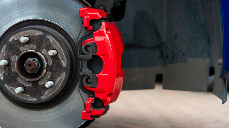 Red two-piston brake caliper on car