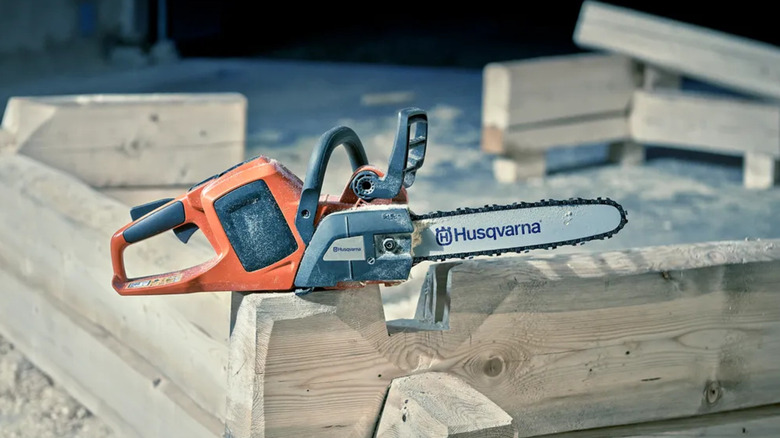 A Husqvarna chainsaw sitting at a worksite
