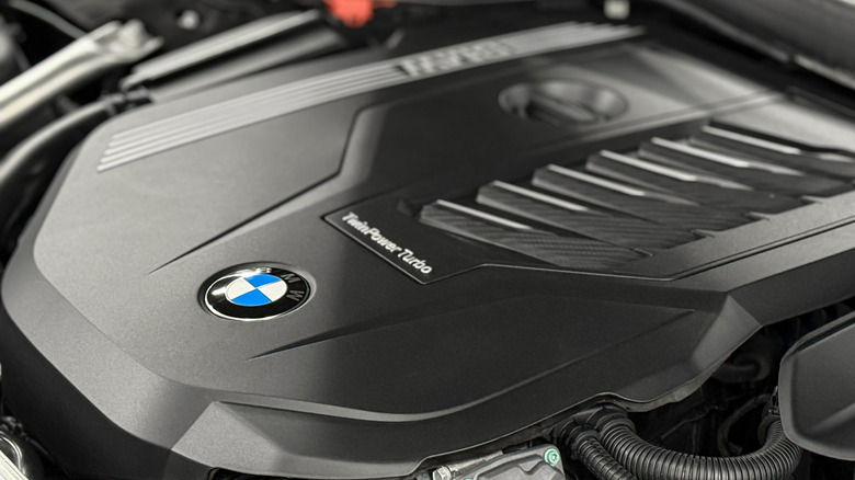 A close-up of a black BMW engine cover.