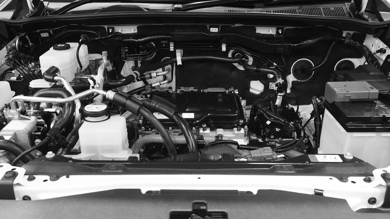 A car's engine bay in black-and-white