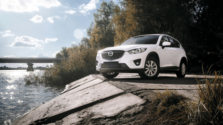 White Mazda CX-5 parked on concrete near water