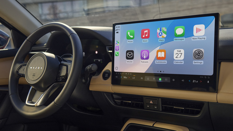 Interior of 2026 Mazda CX-5 with steering wheel and infotainment screen