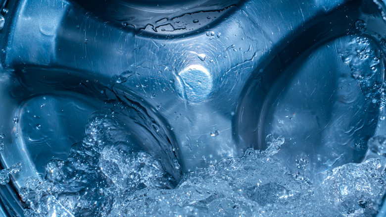A washing machine tub filling with water