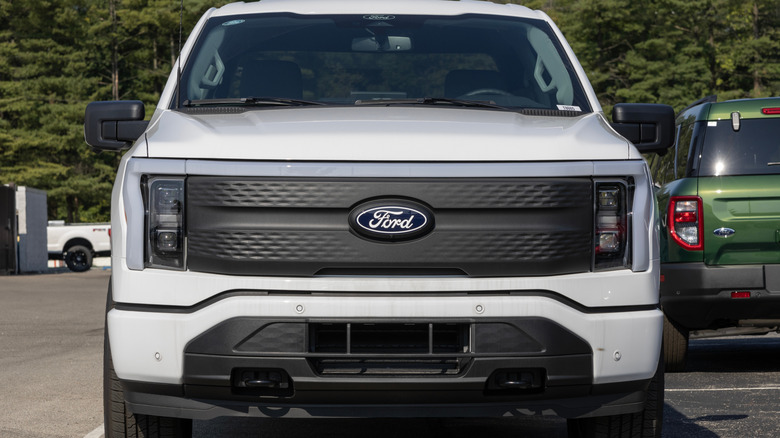 Front-end view of a white Ford F-150 Lightning.